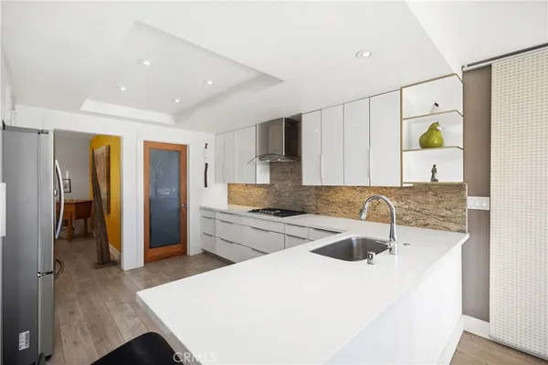 a kitchen with a sink a stove and refrigerator