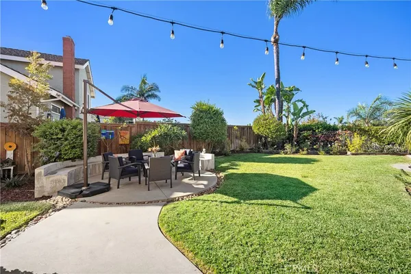 a view of a patio with a table and chairs under an umbrella