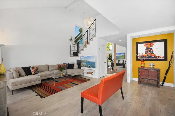 a living room with furniture and a painting on the wall