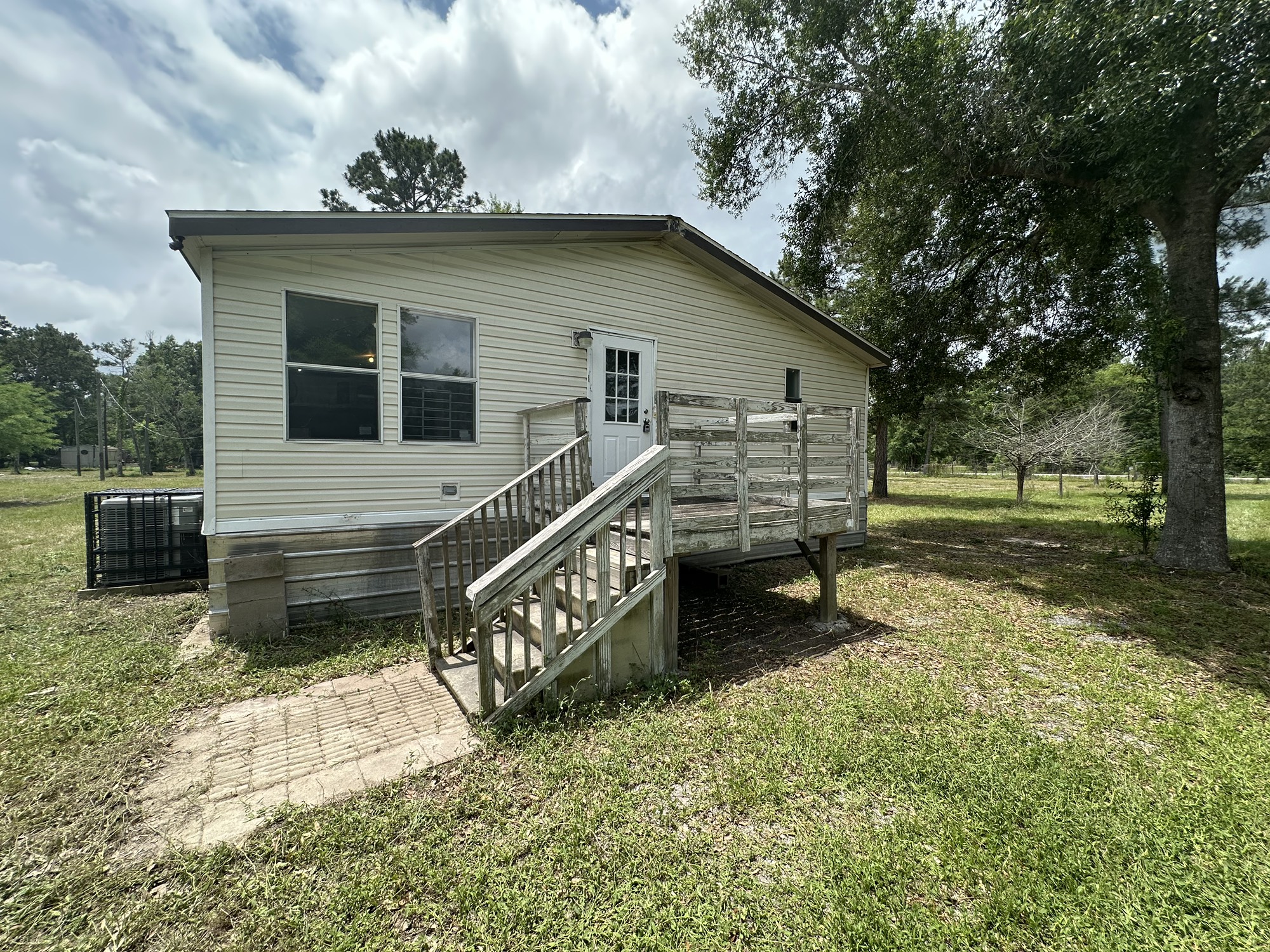 2229 Meekins Road Cleveland, TX 77328 - Photo 37 of 48 a view of a house with a yard