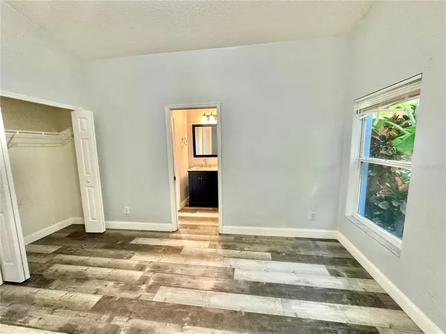 a view of a livingroom with wooden floor and a window