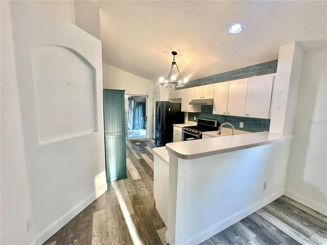 a kitchen with kitchen island a sink stove and refrigerator