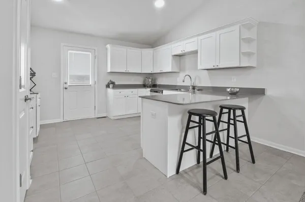 a kitchen with a sink cabinets and appliances