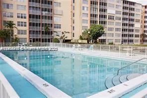 a view of balcony with a lake view and tall buildings
