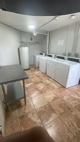 a view of kitchen with a sink wooden cabinets and glass window