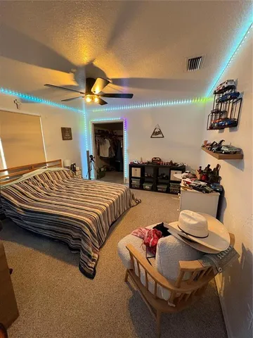 a bedroom with a bed and a chair