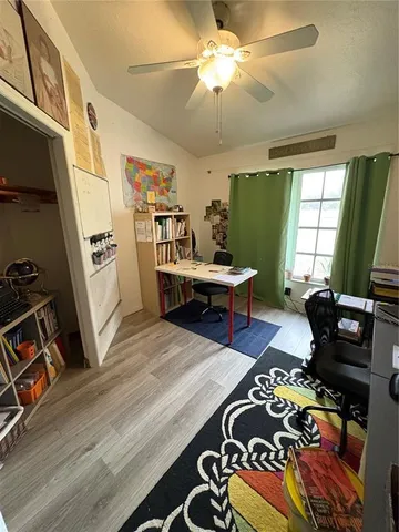 a room with wooden floor and furniture