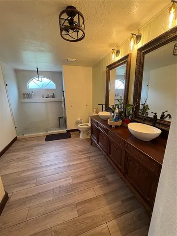 a bathroom with a toilet a sink and a mirror