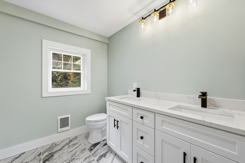 75 Lead Mine Road Southampton, MA 01073 - Photo 34 of 42 a bathroom with a toilet sink and mirror