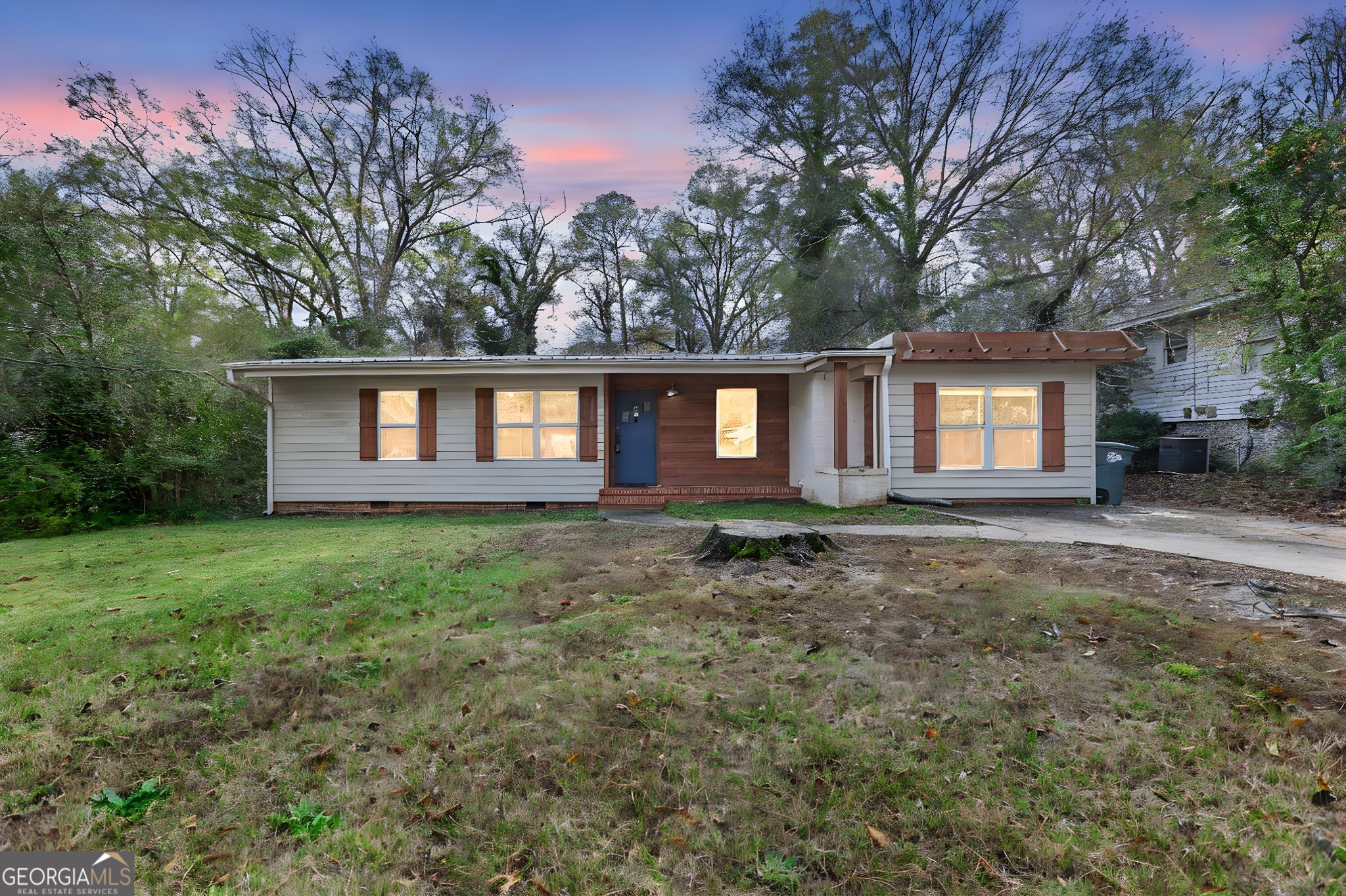 a front view of a house with a garden