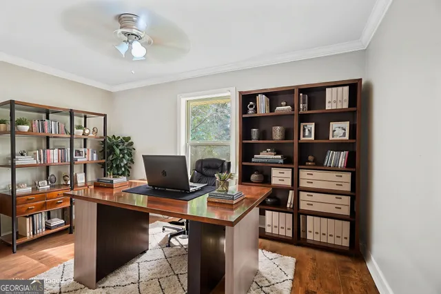 a view of a workspace with furniture and a window