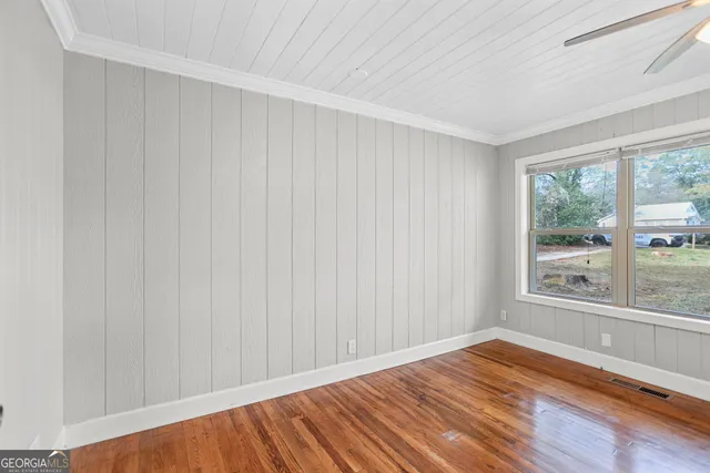 a view of a room with wooden floor and walls