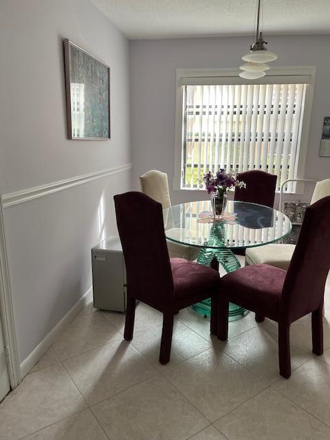 247 Capri F Delray Beach, FL 33484 - Photo 4 of 14 a view of a dining room with furniture window and outside view
