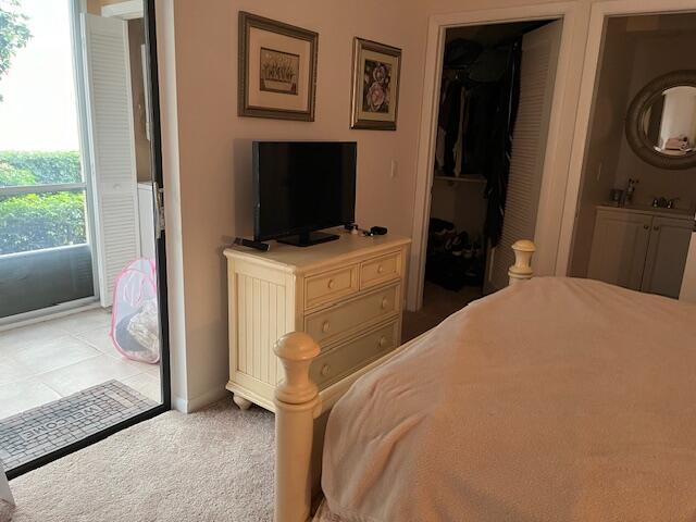 247 Capri F Delray Beach, FL 33484 - Photo 6 of 14 a bedroom with a bed and a television