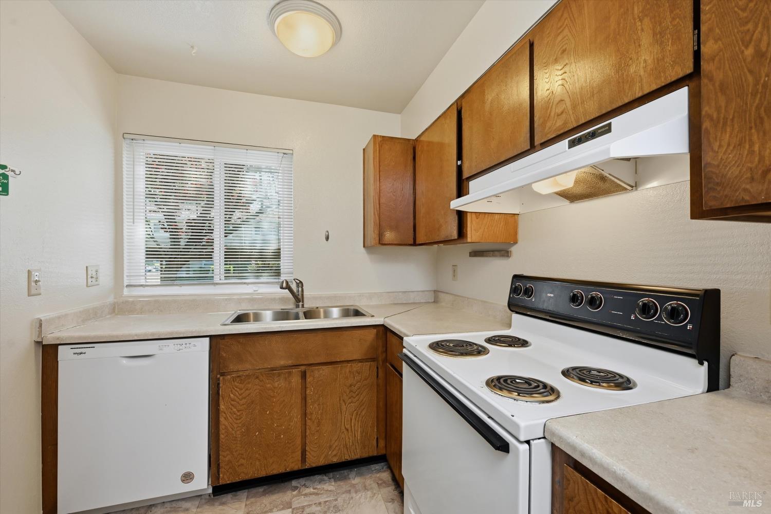 498 Santa Alicia Drive Rohnert Park, CA 94928 - Photo 3 of 18 a kitchen with a sink a stove cabinets and a window