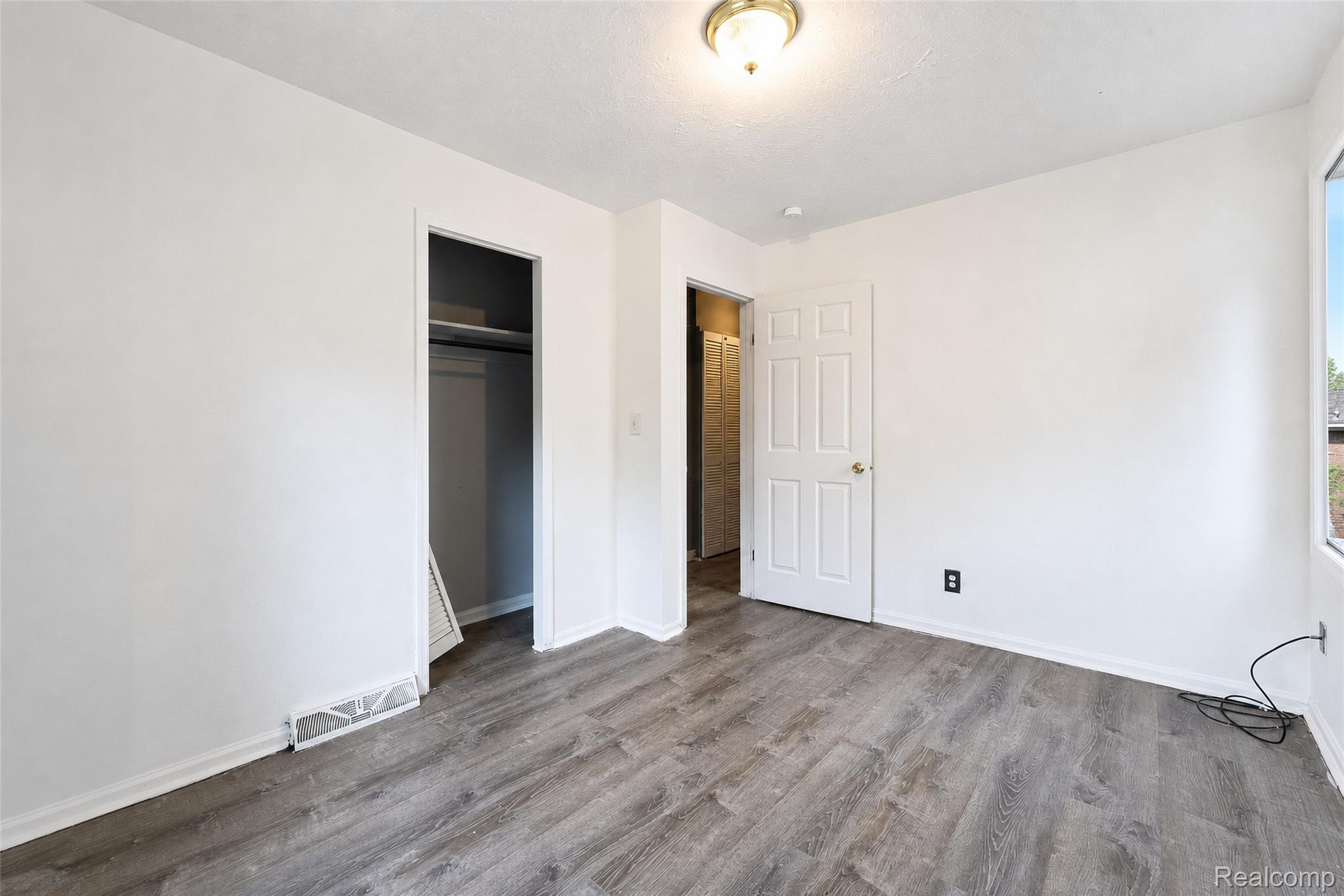 26137 Superior Road Taylor, MI 48180 - Photo 14 of 34 Wood-finish flooring, white painted walls, ceiling-mounted light fixture, interior door, and a built-in closet