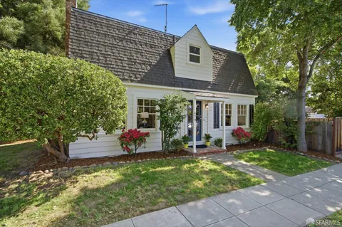 a view of a house with backyard sitting area and garden