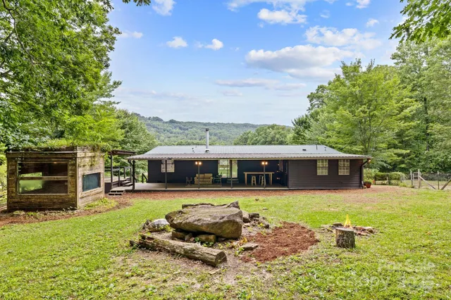 a front view of a house with a yard table and chairs