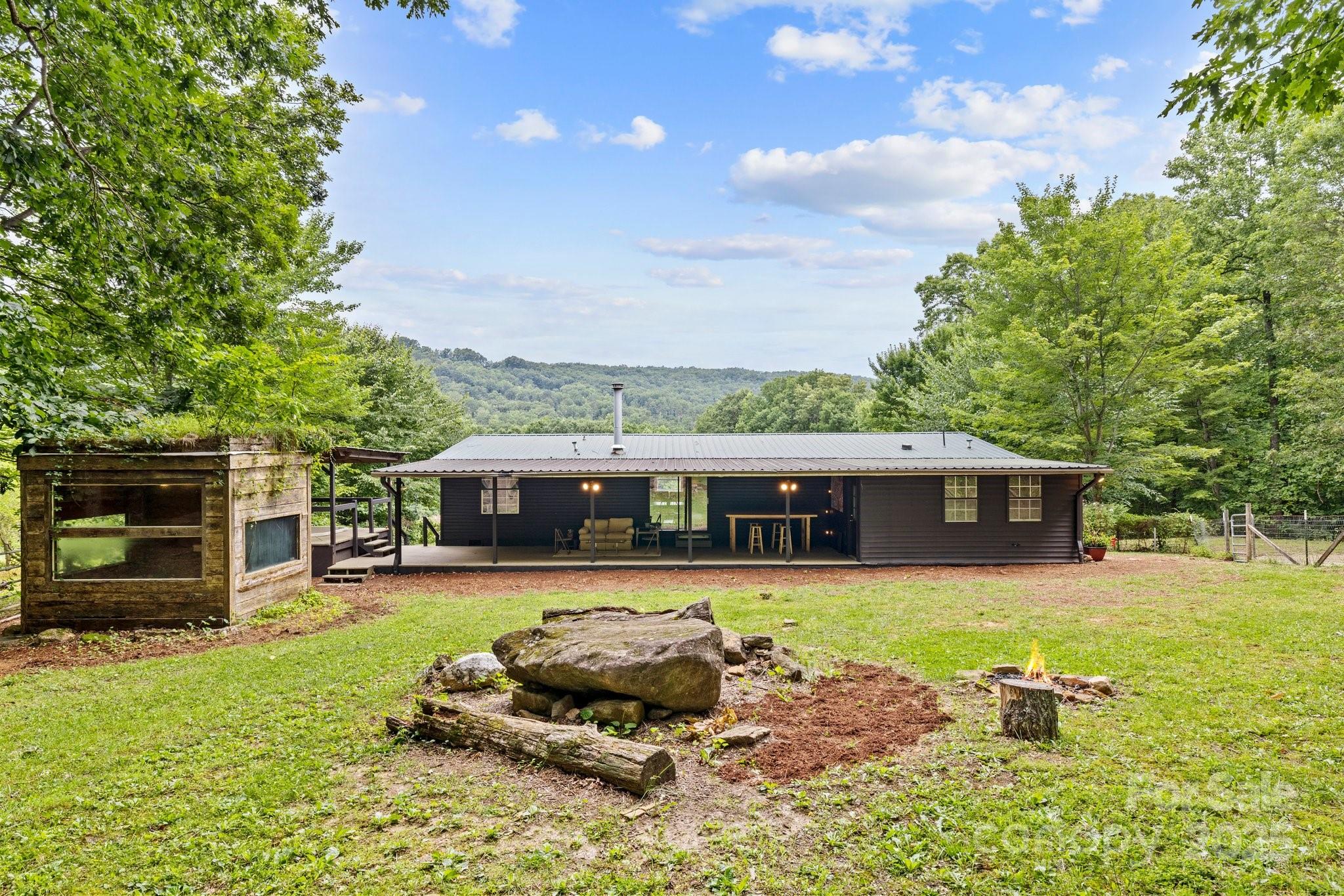 a front view of a house with a yard table and chairs