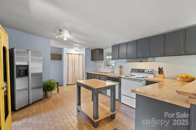 a kitchen with refrigerator a stove and cabinets