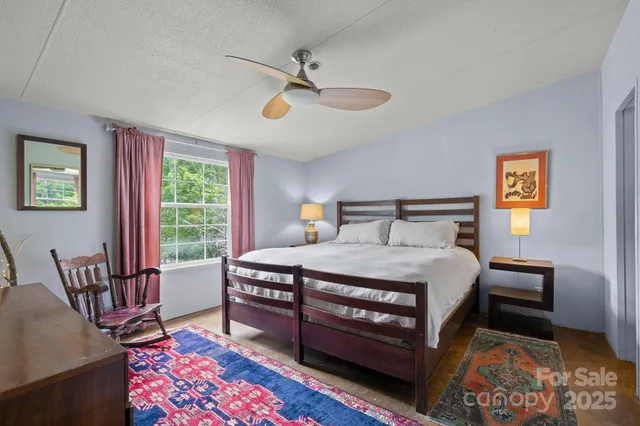 a bedroom with a bed a table and chair