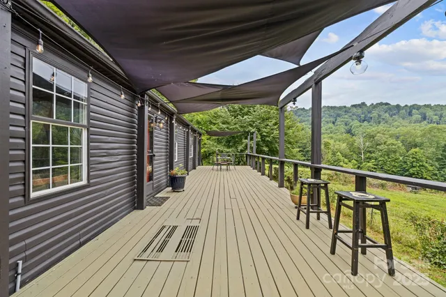a view of balcony with wooden floor and seating