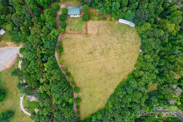 a aerial view of a multi story residential apartment building with a yard
