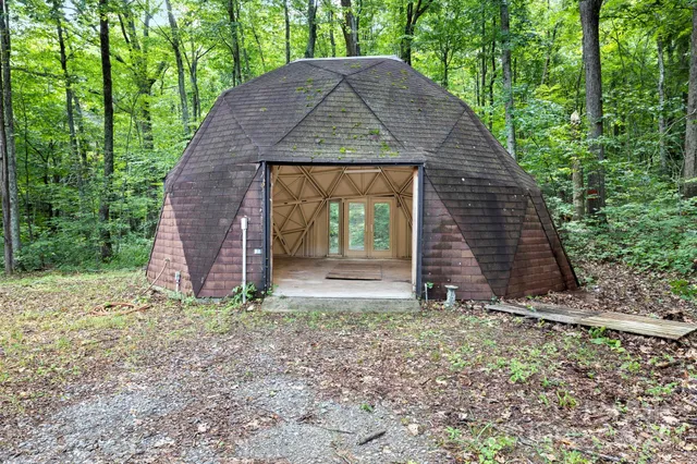 a view of a room with a bed and a window