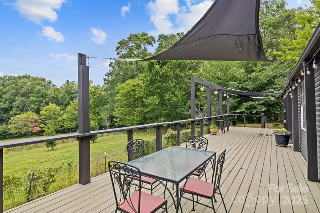 a balcony with wooden floor and outdoor seating