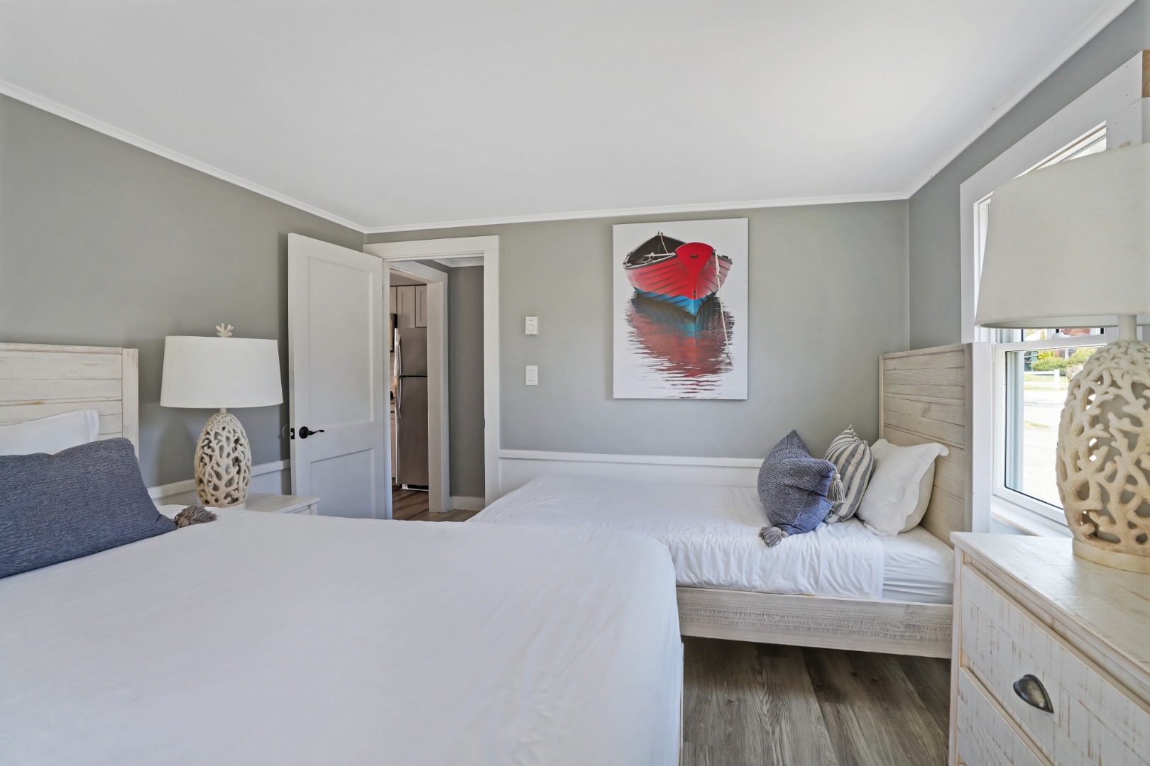20 Peases Point Way North, Unit 4 Edgartown, MA 02539 - Photo 7 of 11 a bedroom with a bed and a painting on the wall