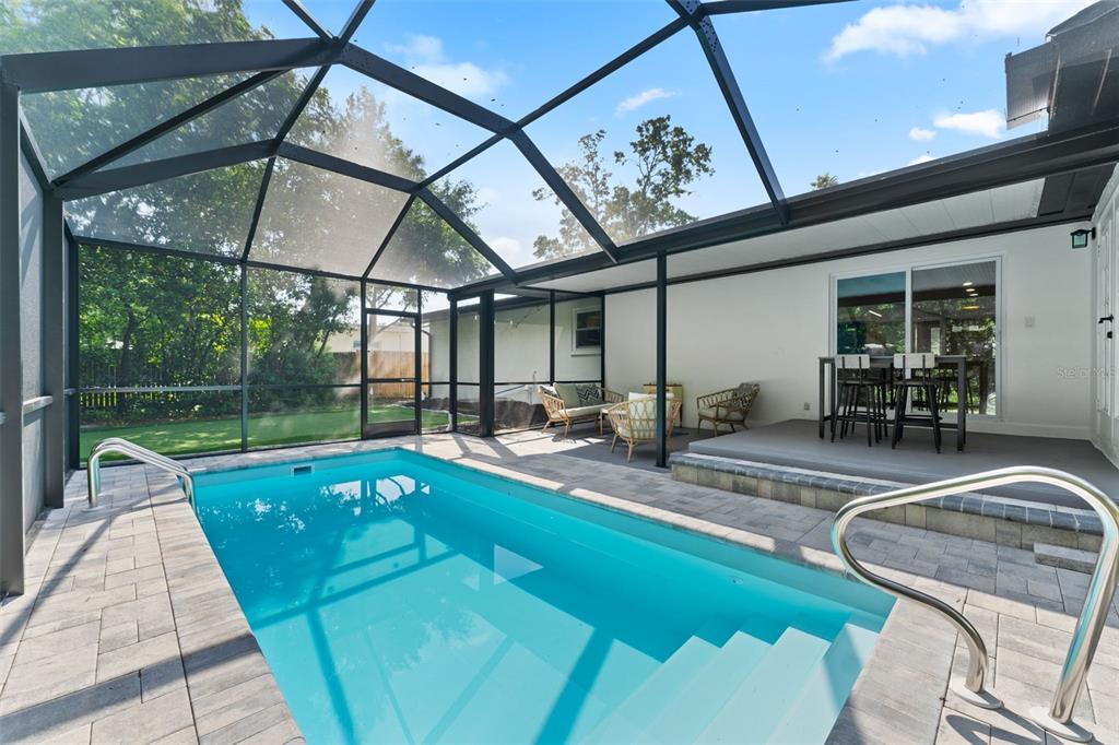 1830 Lakeview Road Clearwater, FL 33764 - Photo 1 of 38 a view of a swimming pool with a patio and a yard