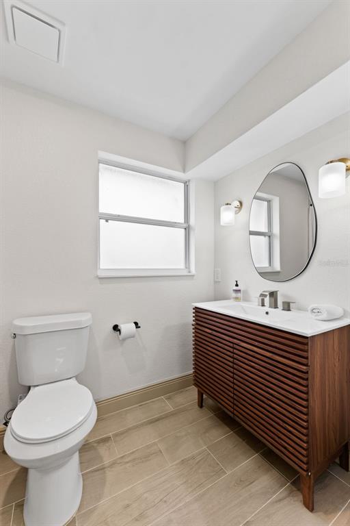 1830 Lakeview Road Clearwater, FL 33764 - Photo 24 of 38 a bathroom with a toilet a sink and a mirror