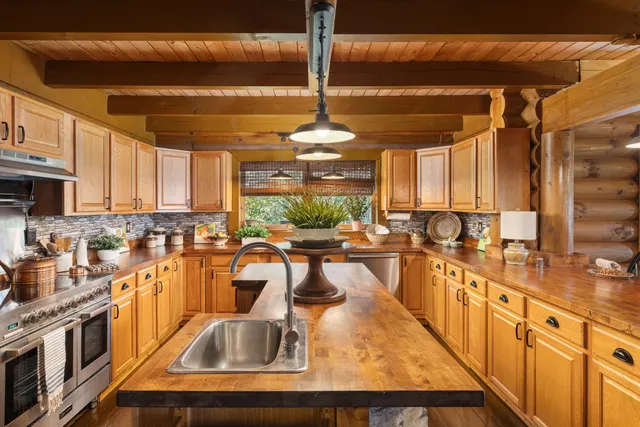 a view of an empty room with wooden floor and closet area