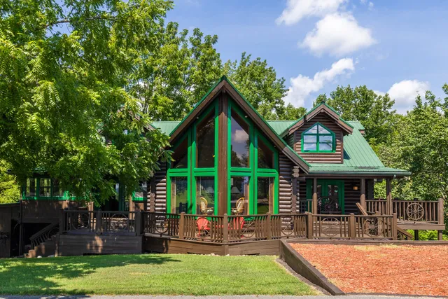 a outdoor space with patio the couches and a fireplace