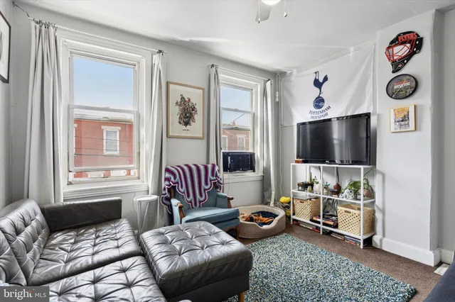 a living room with furniture a couch and dresser