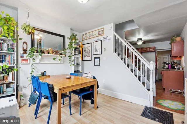 a view of a workspace with furniture and wooden floor