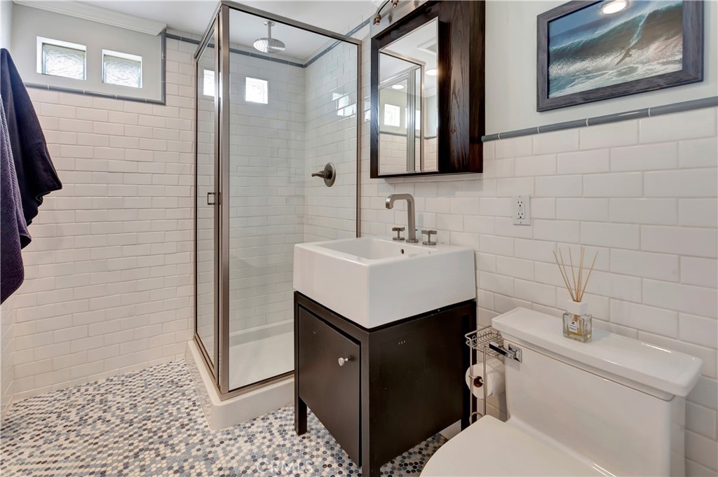 1102 West Oceanfront Newport Beach, CA 92661 - Photo 15 of 32 a bathroom with a sink toilet and shower