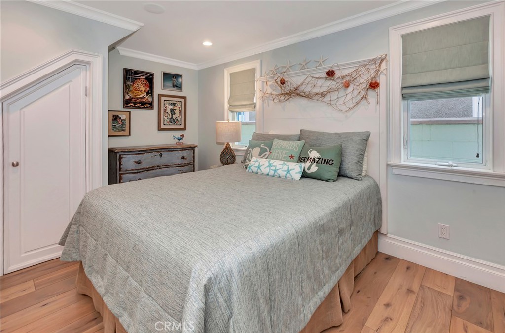 1102 West Oceanfront Newport Beach, CA 92661 - Photo 18 of 32 a bedroom with a large bed and a window