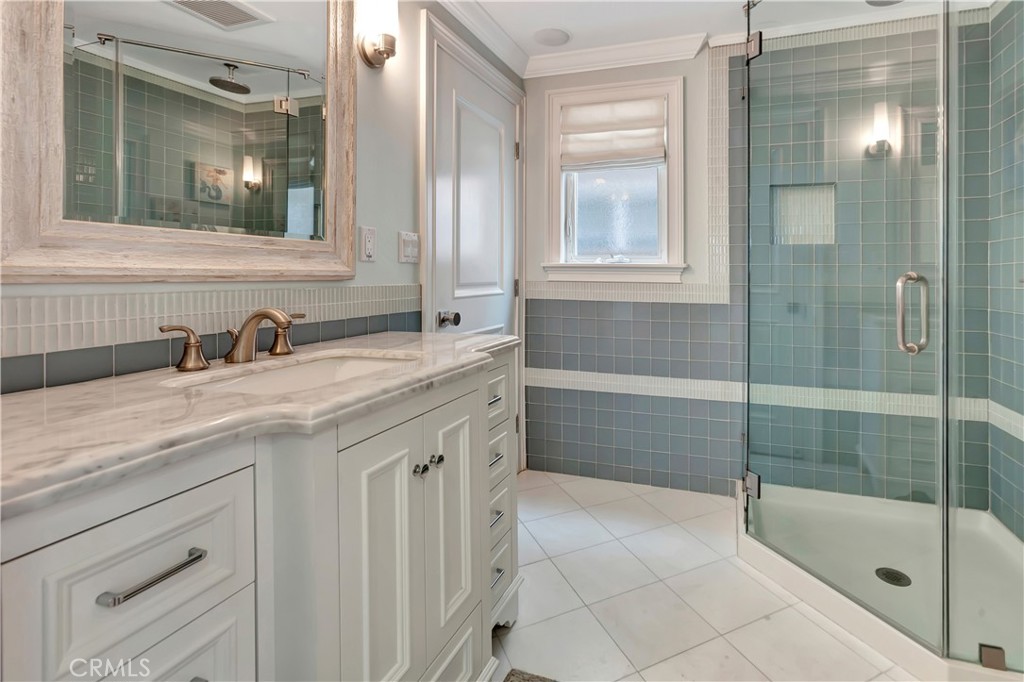 1102 West Oceanfront Newport Beach, CA 92661 - Photo 19 of 32 a bathroom with a shower sink and mirror