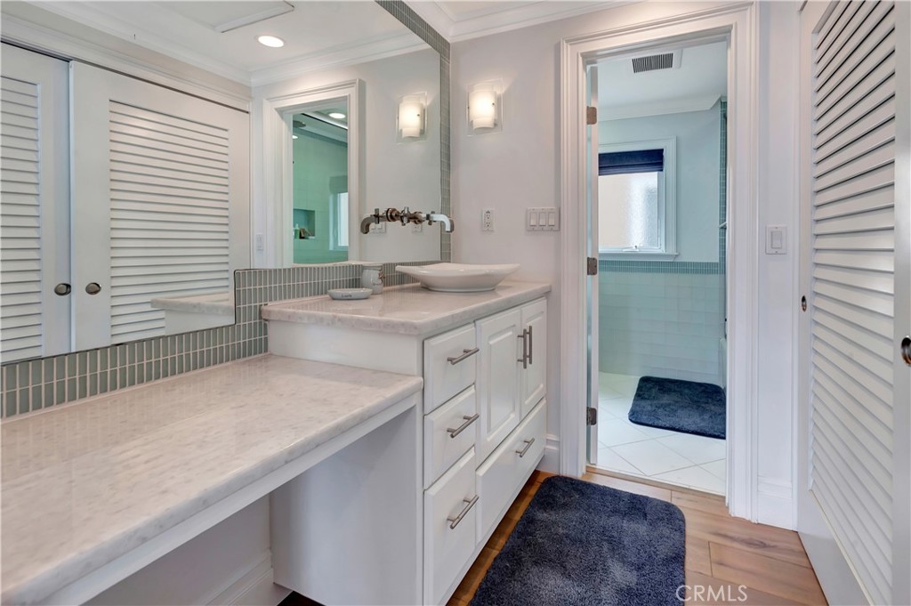 1102 West Oceanfront Newport Beach, CA 92661 - Photo 22 of 32 a spacious bathroom with a granite countertop sink and a mirror