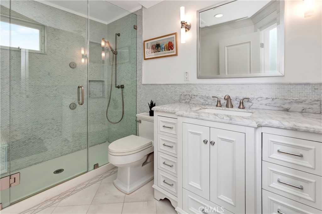 1102 West Oceanfront Newport Beach, CA 92661 - Photo 26 of 32 a bathroom with a sink toilet and shower