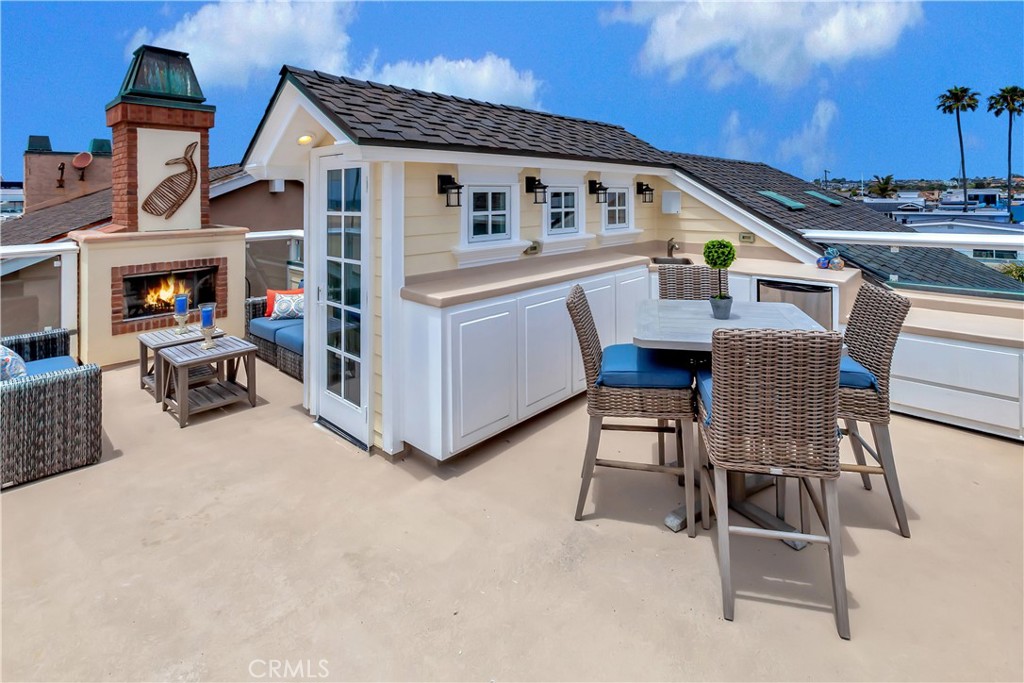 1102 West Oceanfront Newport Beach, CA 92661 - Photo 28 of 32 a view of a house with backyard and sitting area