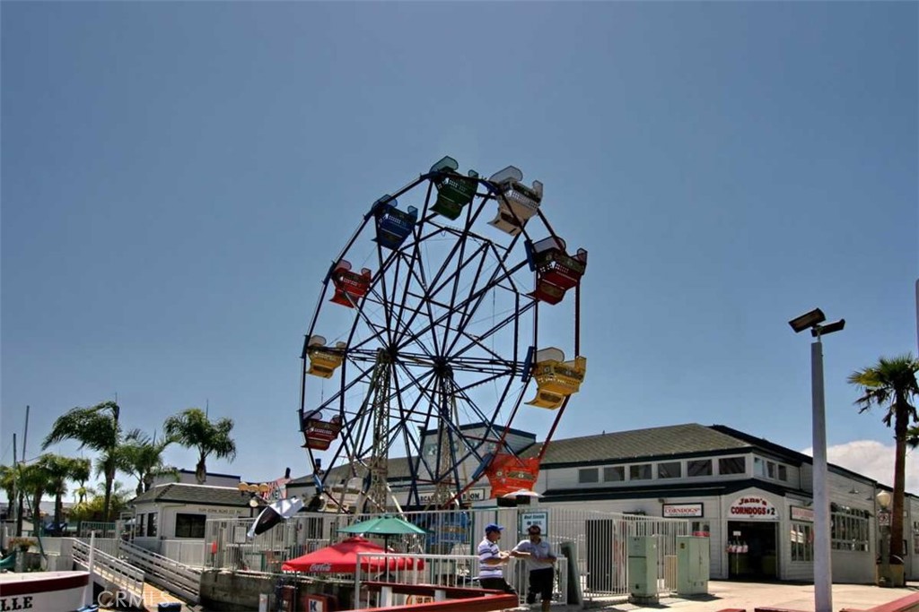 1102 West Oceanfront Newport Beach, CA 92661 - Photo 32 of 32 a front view of a building with retail shop and cars