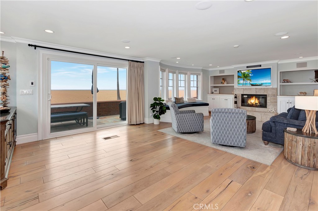 1102 West Oceanfront Newport Beach, CA 92661 - Photo 7 of 32 a living room with furniture and a flat screen tv