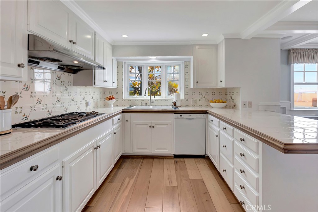 1102 West Oceanfront Newport Beach, CA 92661 - Photo 10 of 32 a kitchen with sink cabinets and window