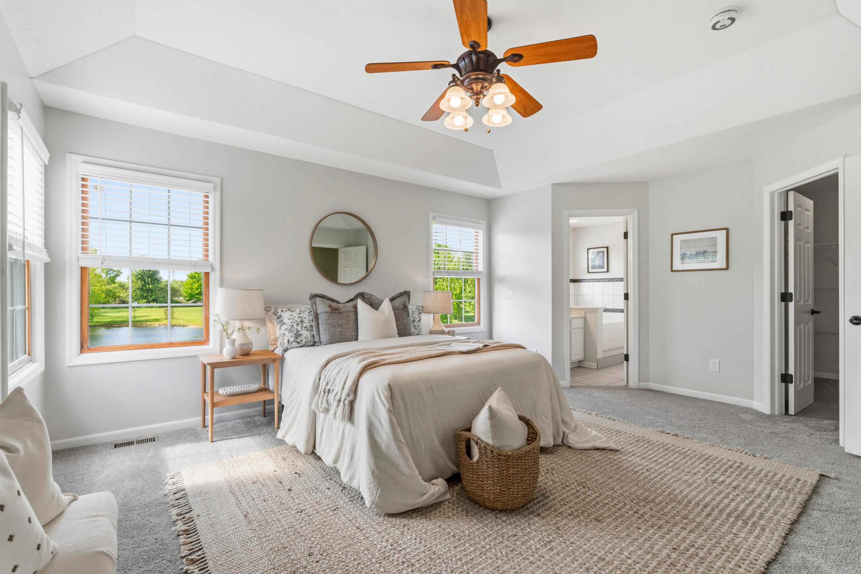 8507 Benner Road Johnstown, OH 43031 - Photo 28 of 69 Primary Suite with tray ceiling and large walk-in closet plus Ensuite bath with double vanity, soaking tub and walk-in shower.