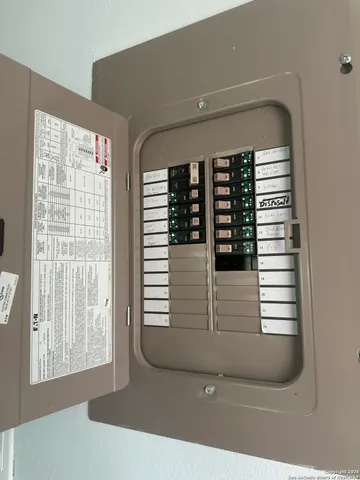 a kitchen with a sink a refrigerator and a stove top oven