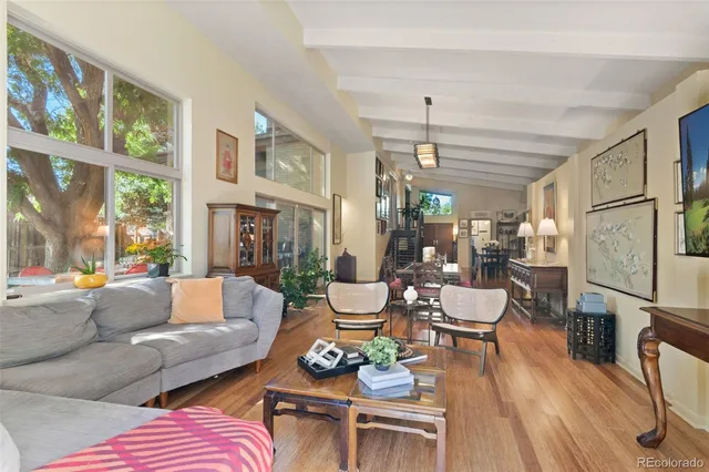 a living room with patio furniture and a large window