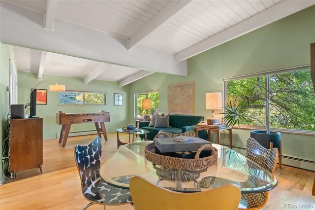 a living room with fireplace furniture and a large window