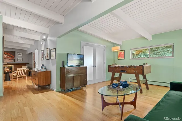 a living room with furniture and a wooden floor